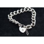 Silver bracelet with heart shaped locket