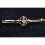 9ct Gold pin brooch set with central topaz