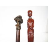 2 Walking sticks,1 depicting a African lady & 1 wi