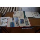 Collection of stamp albums together with a postcar