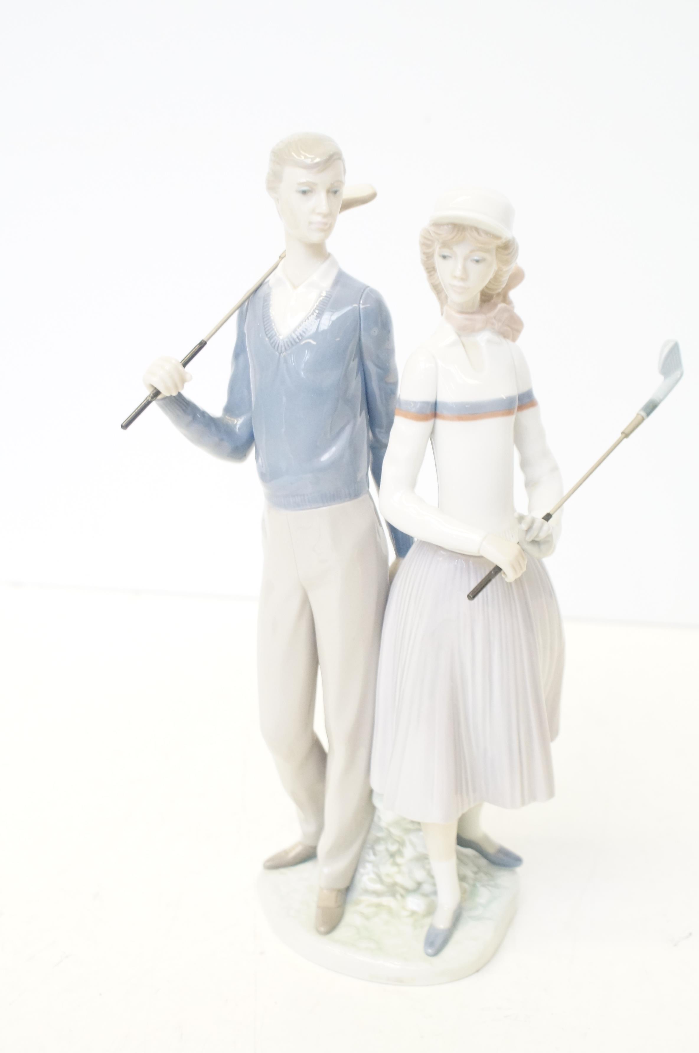 Lladro golfing couple with box No 1453 Height 34 c