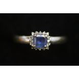 18ct Gold ring set with central blue stone surroun