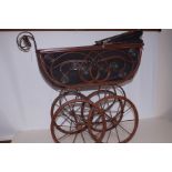 A reproduction Victorian dolls' pram with black linen