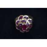 9ct Gold ring set with red stones Weight 5.8g Size