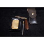 Zippo cigarette lighter together with a cased Rodg