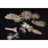 10 White metal brooches possibly silver