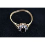 9ct Gold sapphire ring surround by white gem stone