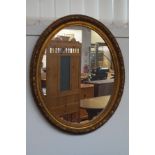 Gilt framed oval mirror