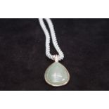 Silver mounted jade pendant