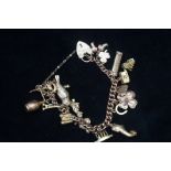9ct Gold charm bracelet, 17 charms Weight 44.5g wi