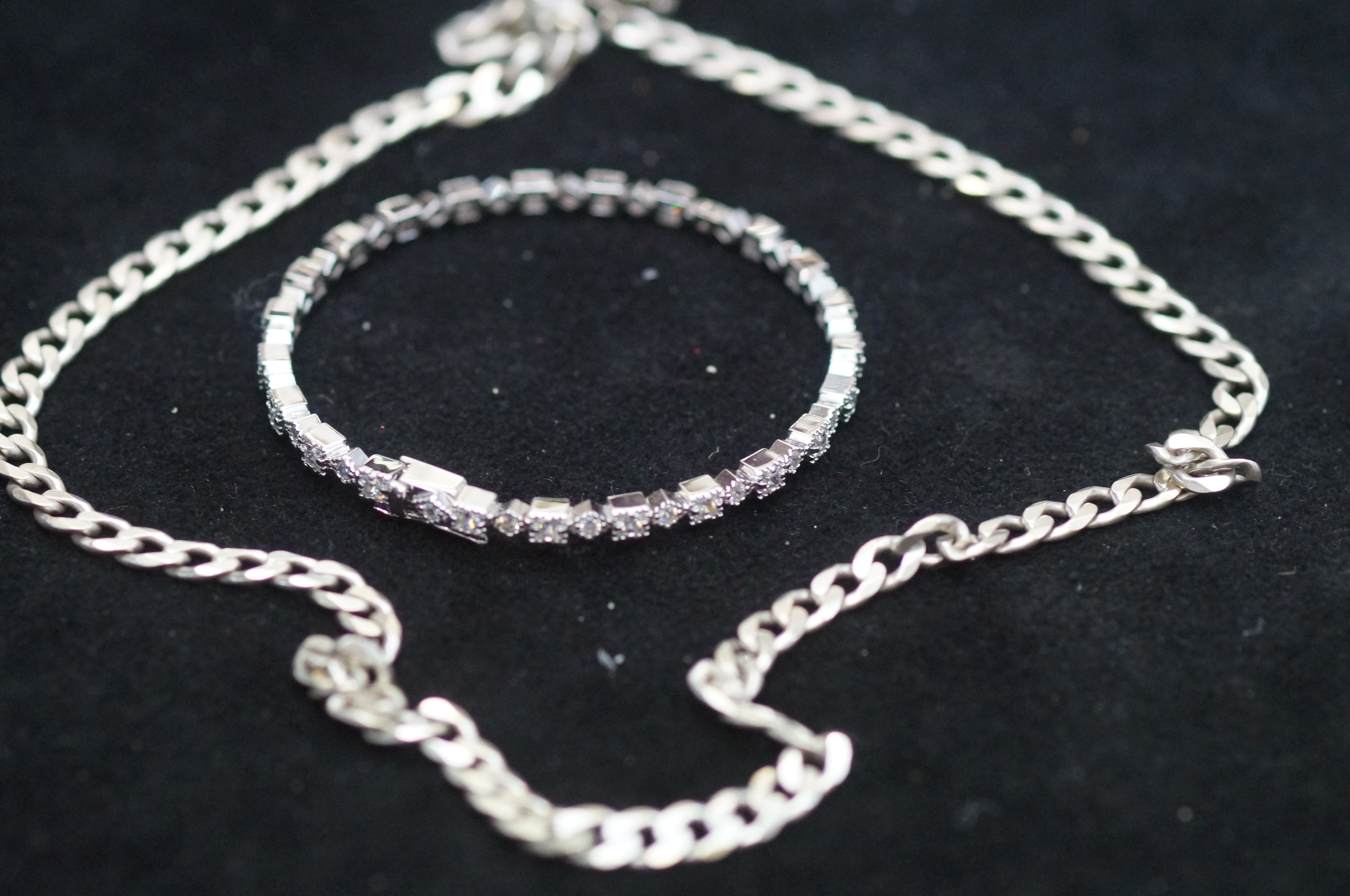 Silver curb chain together with a silver bangle