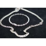 Silver curb chain together with a silver bangle