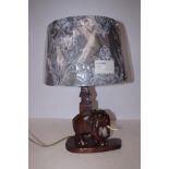 Carved wooden lamp base with a new lamp shade
