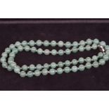 Jade beaded necklace, knotted with silver clasp