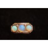 Yellow metal ring tested for gold set with 3 opals