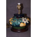 A Moorcroft lamp on a wooden base