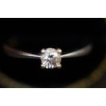 Solitaire diamond set on a 9ct white gold band Size O