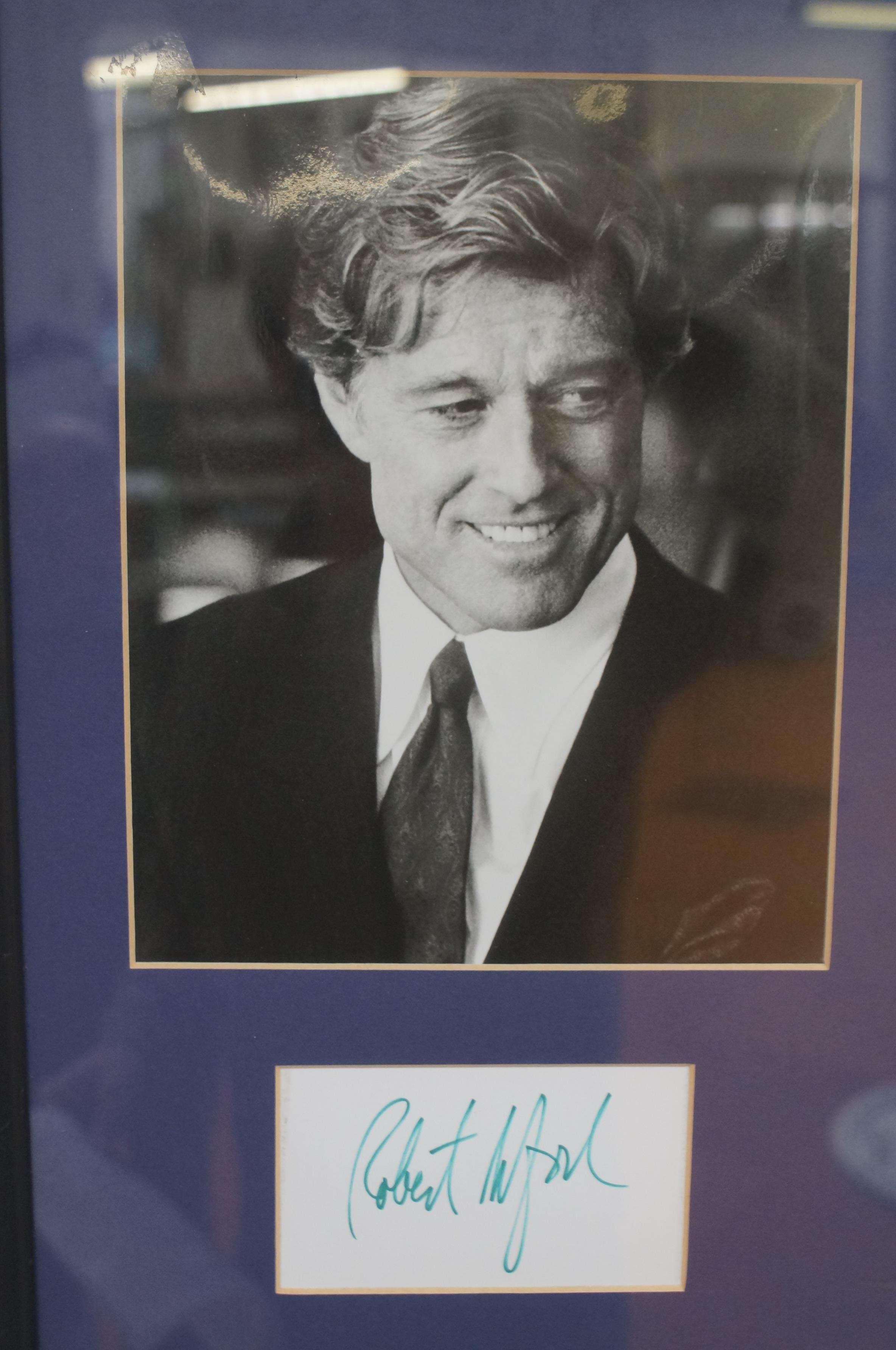 Framed photograph of Robert Redford with signed pa