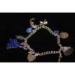 Silver charm bracelet with 10 charms attached
