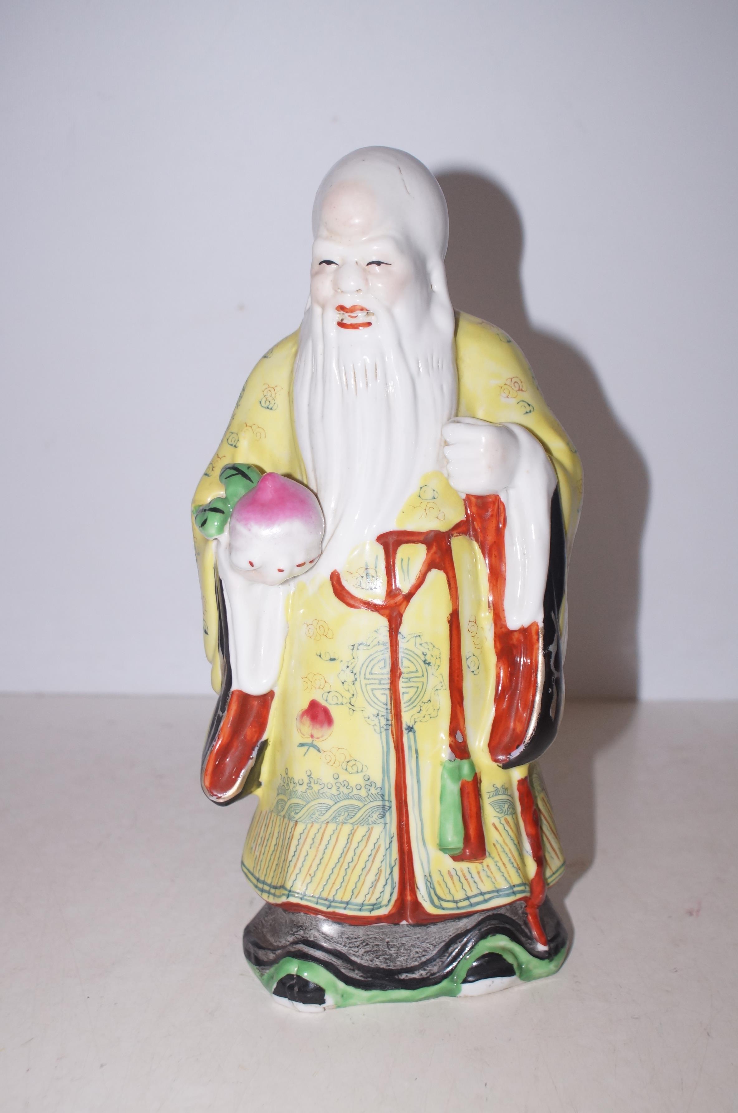 Oriental figure, stamped to base Height 29 cm