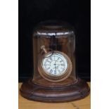 Pocket watch in glass dome on leather base