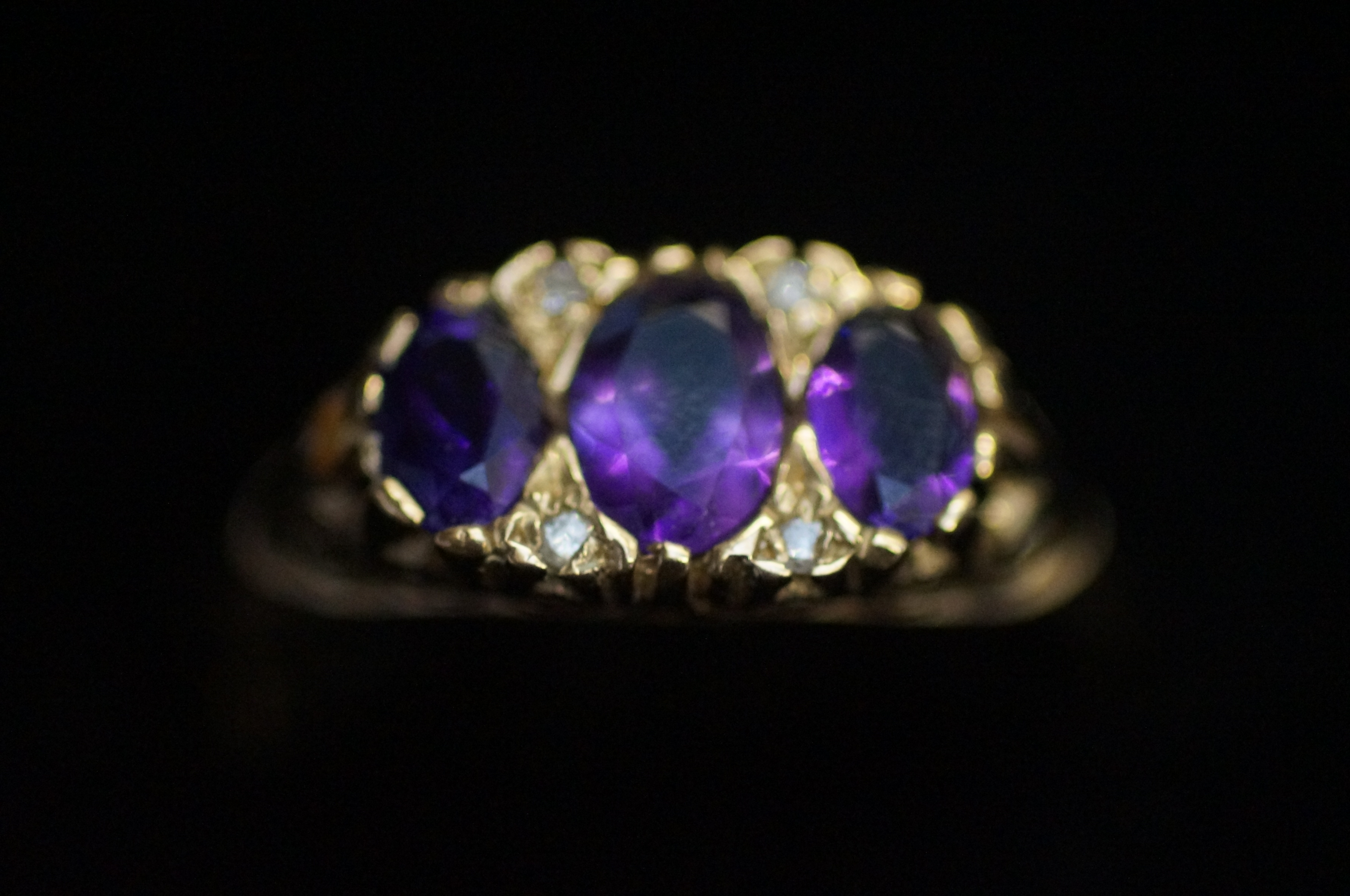 9ct Gold dress ring, set with 3 purple stones Size