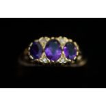9ct Gold dress ring, set with 3 purple stones Size