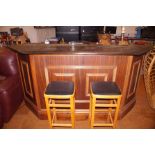 A home bar with beer pump and two bar stools