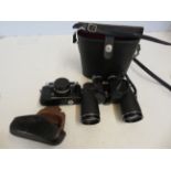 A pair of binoculars together with a vintage camer