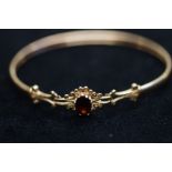 9ct gold bangle set with central garnet 6.3 grams