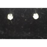 A pair of 9ct white gold stud diamond earrings