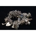 Silver charm bracelet with 26 charms
