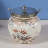 A pottery biscuit barrel with silver plated lid