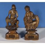 A pair of antique Chinese soapstone figures seated Lohans on bases, 22cm tall