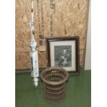 A vintage gate post, cane litter basket and a framed photograph