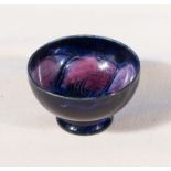 A 1930's miniature blue ground Moorcroft pin dish with anemone flower centre, 2" diameter 1.25"