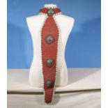 An antique tribal head dress with sheath tail decorated in red coral beads and small cowery