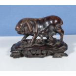 An antique Chinese soapstone figure of a pig with piglets on a base