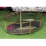 A brass framed oval coffee table.