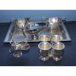 A silver plated tray with sauce boats and egg cups