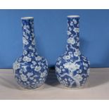 A pair of Chinese blue and white vases 36cm tall some damage to necks.