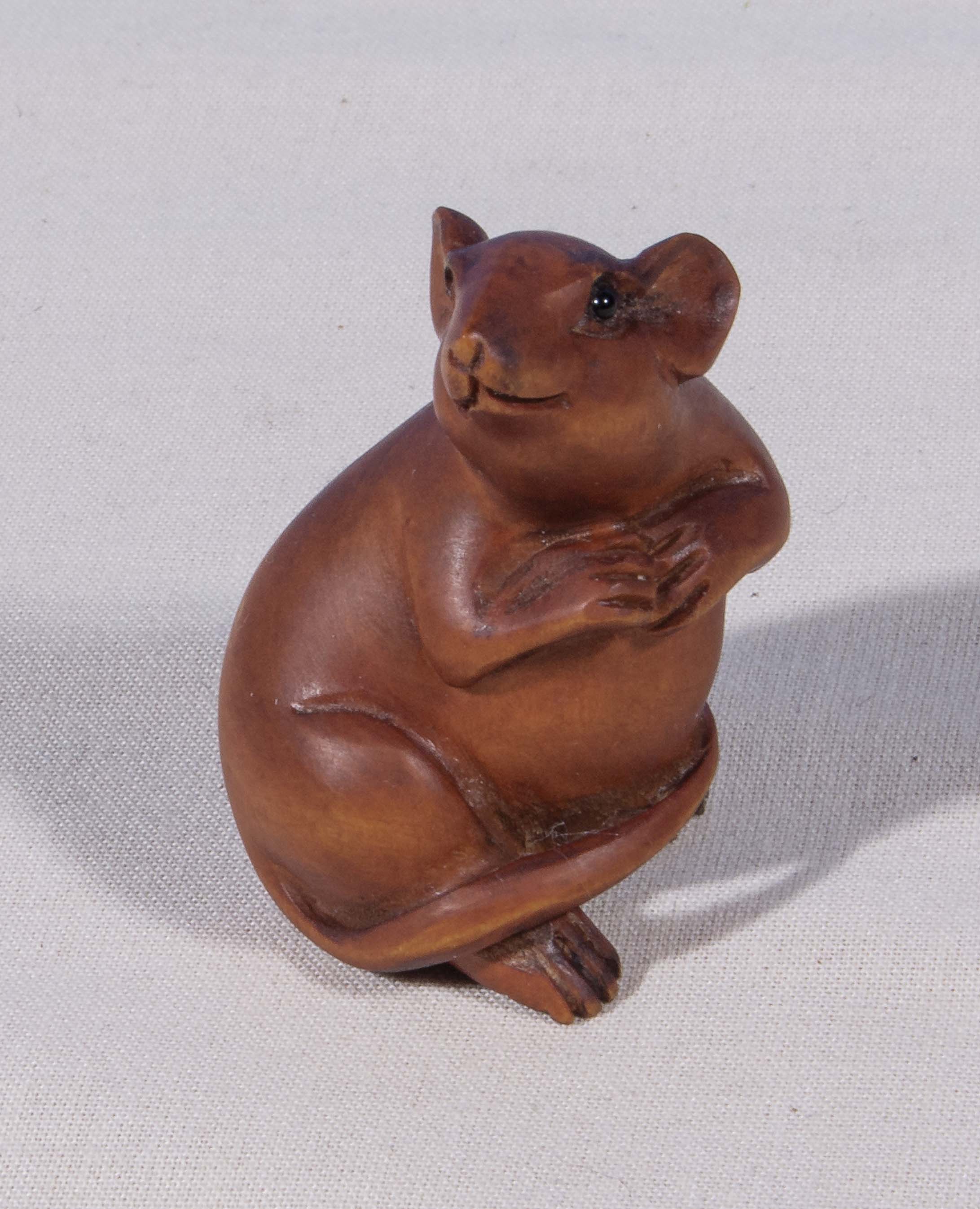 A small carved wood figure of a rat, signed to base