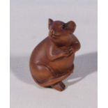 A small carved wood figure of a rat, signed to base