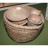 A basket of terracotta plant pots
