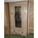 A Victorian pine wardrobe with mirror door.