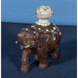 A Japanese shibiyana carved wood elephant decorated with red coral and jewelled decoration with a
