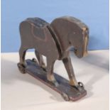 A vintage pull along wooden horse