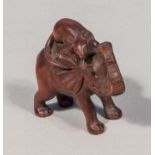 A wood netsuke, elephant and rat, signed