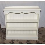 A white painted open bookcase