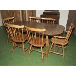 A dining table and six pine kitchen chairs